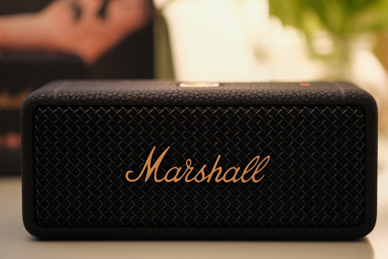 services-02 Close-up image of a Marshall portable Bluetooth speaker with textured design.