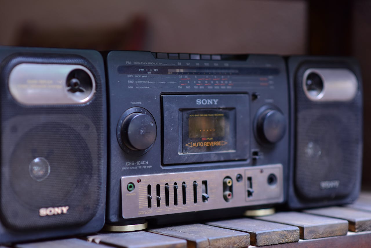 services-01 Close-up of a vintage Sony boombox cassette player with speakers on a wooden surface.